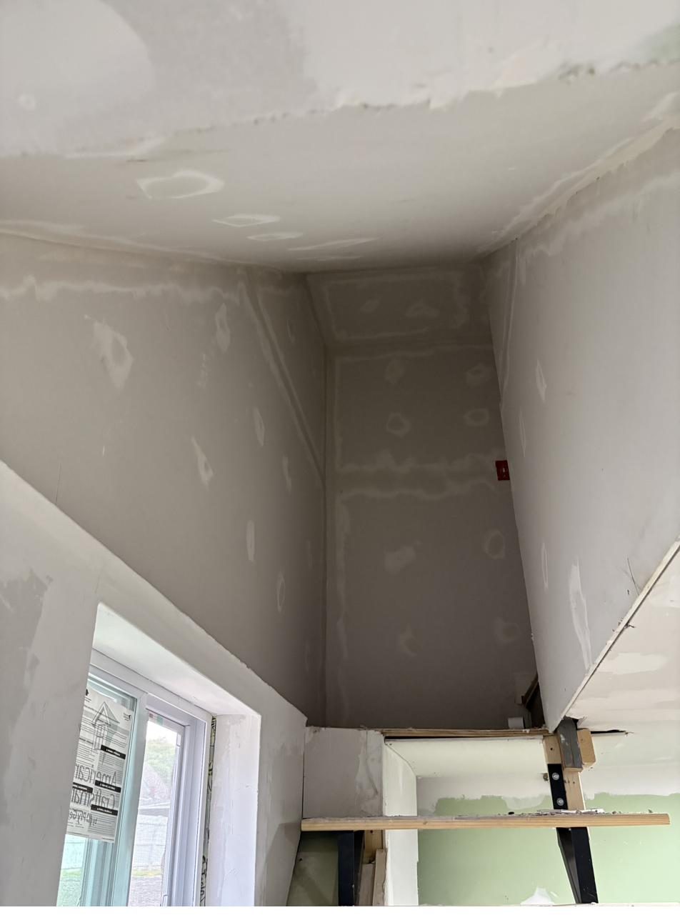 Drywall mudding and finishing in progress