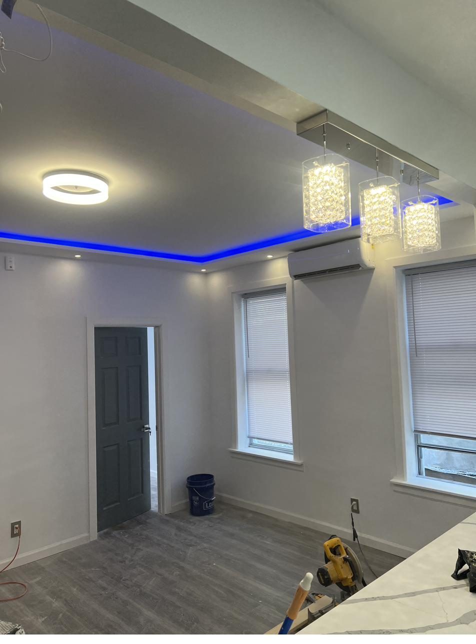 Living room with LED cove lighting and crystal pendants